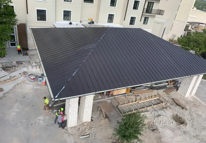 Metal roofing installation team working on a commercial building in Fort Pierce North